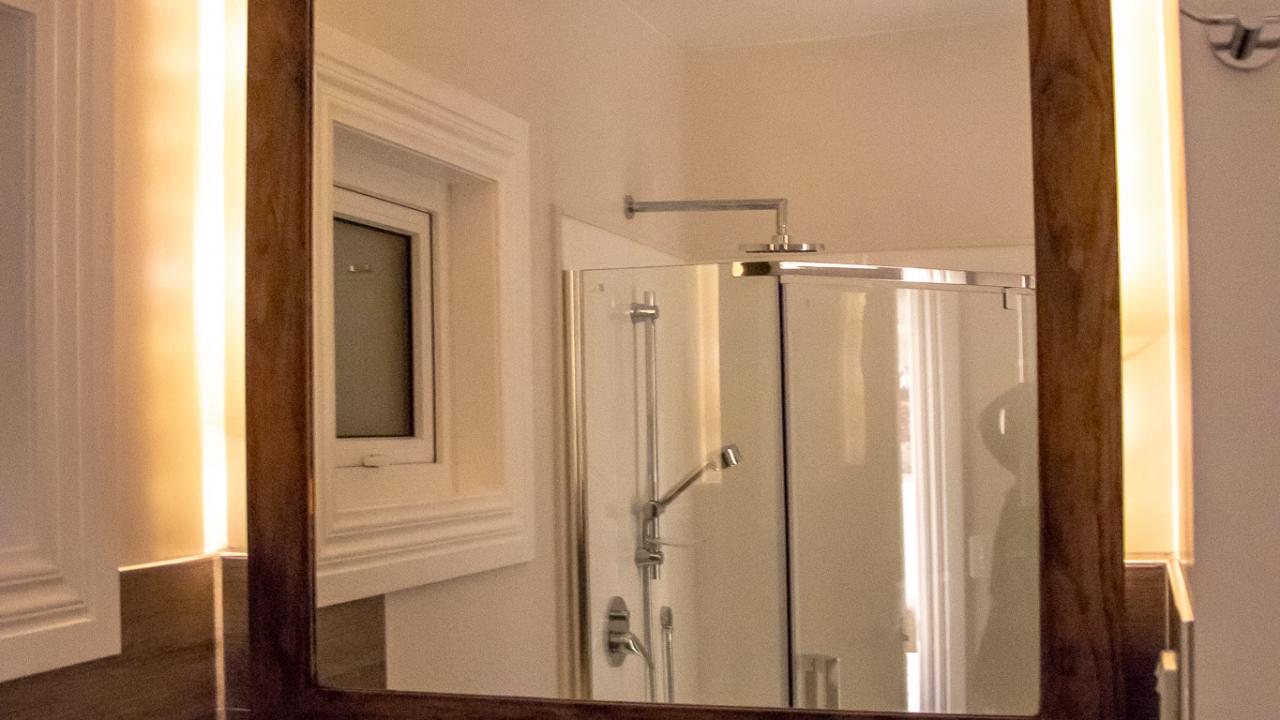 The ensuite in Mangateitei shower room, with rain shower shown in the reflection.