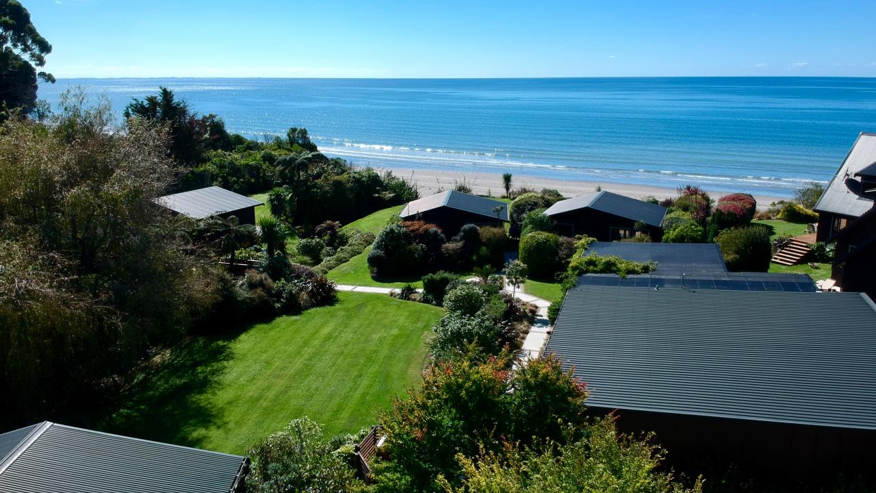 Relax in the idyllic, intimate garden setting nestled in right next to the private, sandy beach.
