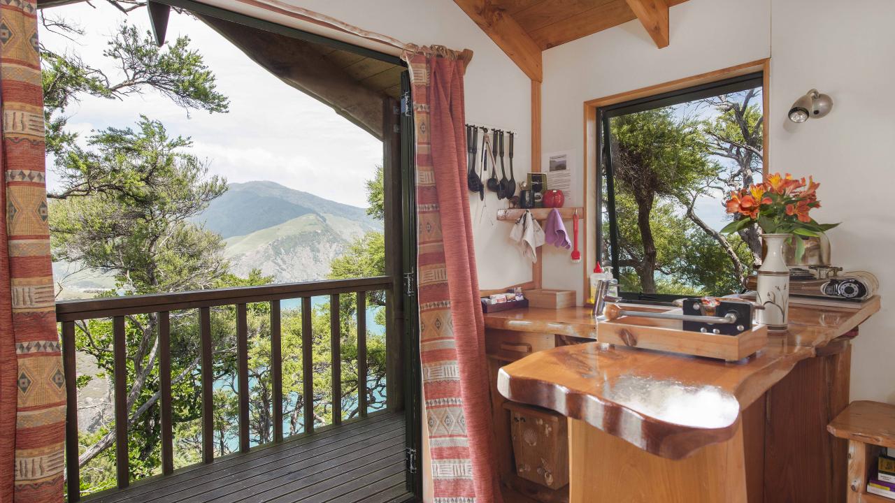 Inside Rocky Point Hut, bar bench, kitchenette, balcony