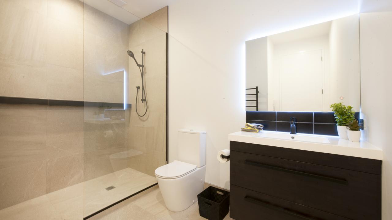 Master bedroom ensuite with walk in tile shower, toilet & vanity
