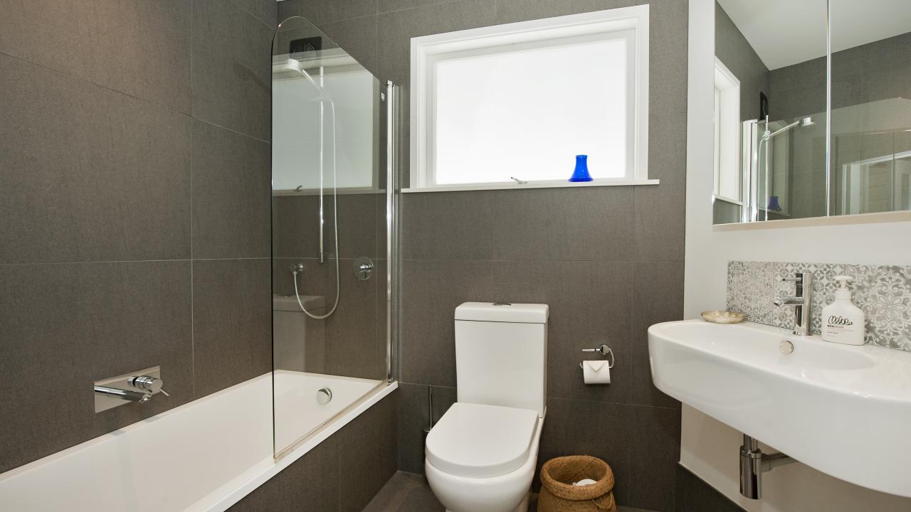 Shower over bath, toilet & basin. Beautifully renovated with frameless showers, beautiful tiles & underfloor heating