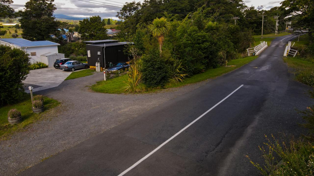 Drone view of Two Rivers Ohakune showing the quiet road, we are located just after the white bridge.  To the right of the picture is a 10 minute riverside walk back to town.