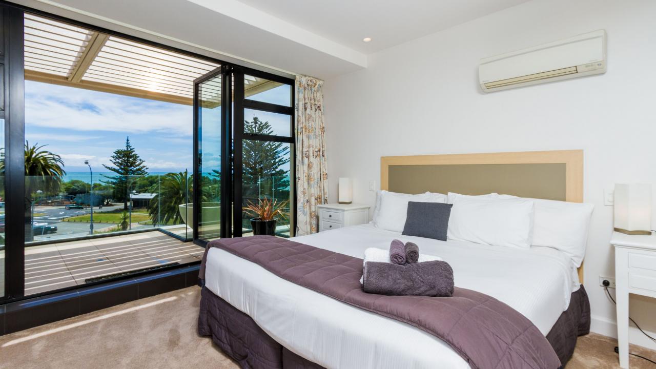 Master bedroom with King bed, ensuite bathroom & sea views