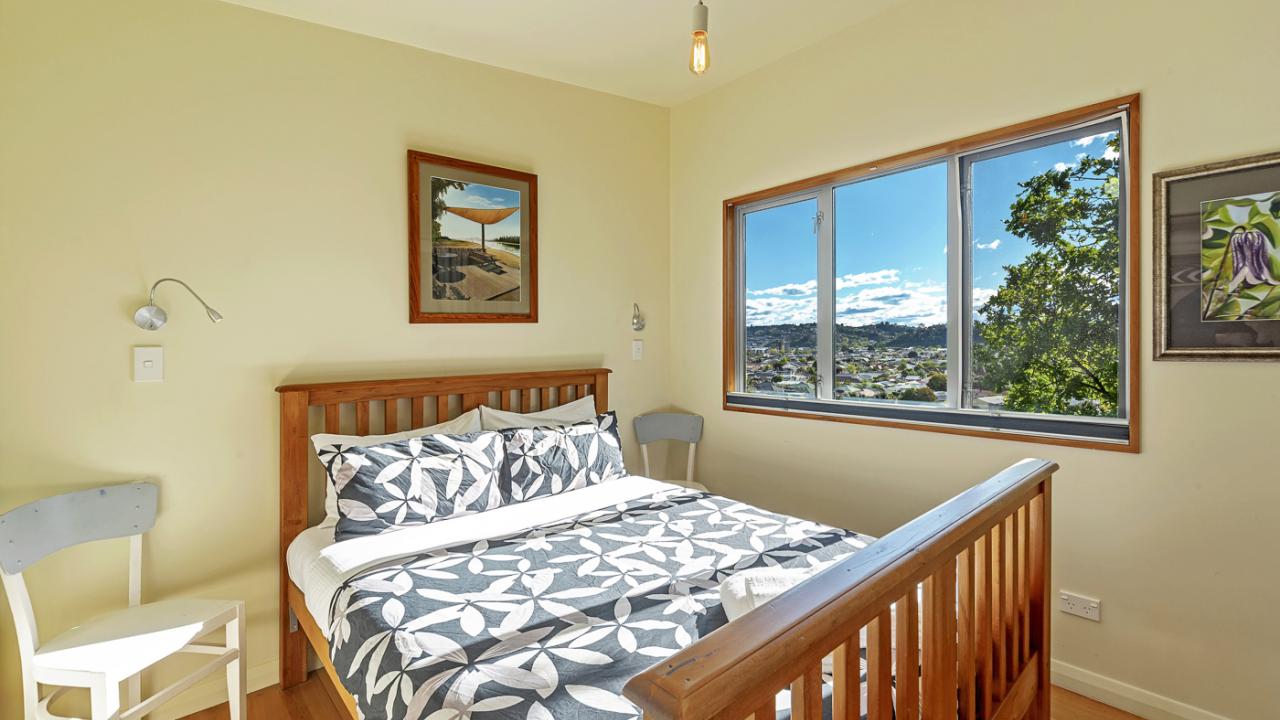 Bedroom with Queen bed and views out over the city