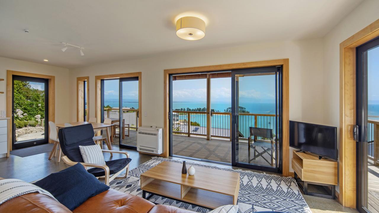 Light-filled open-plan living and dining with intimate sea views.