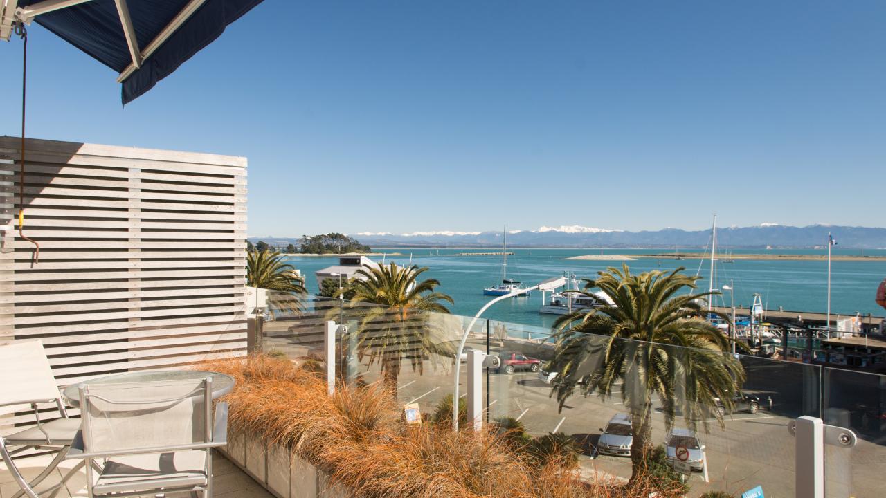 Balcony with views & outdoor setting.
