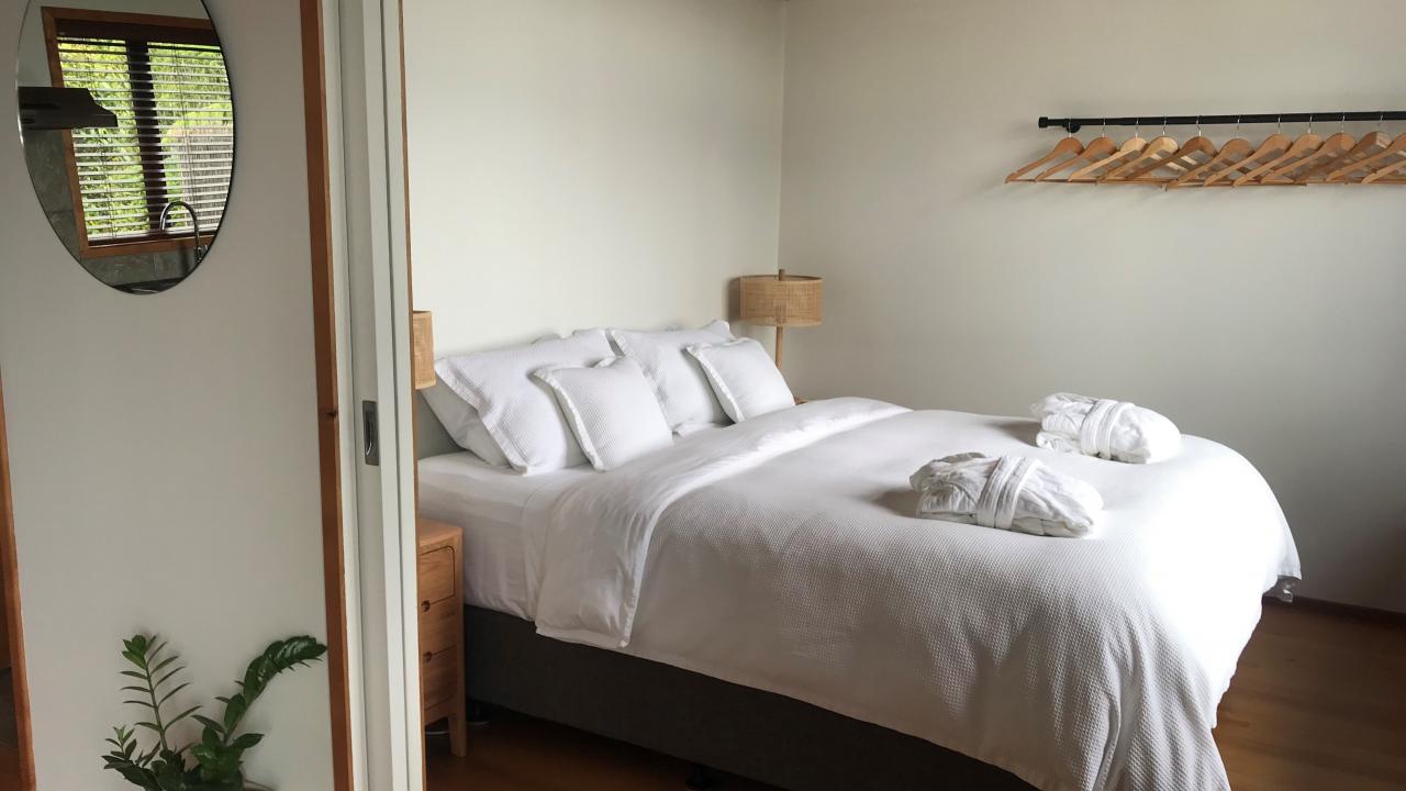 King-size or twin beds face out a large, bi-fold window to the sea and sunrise.