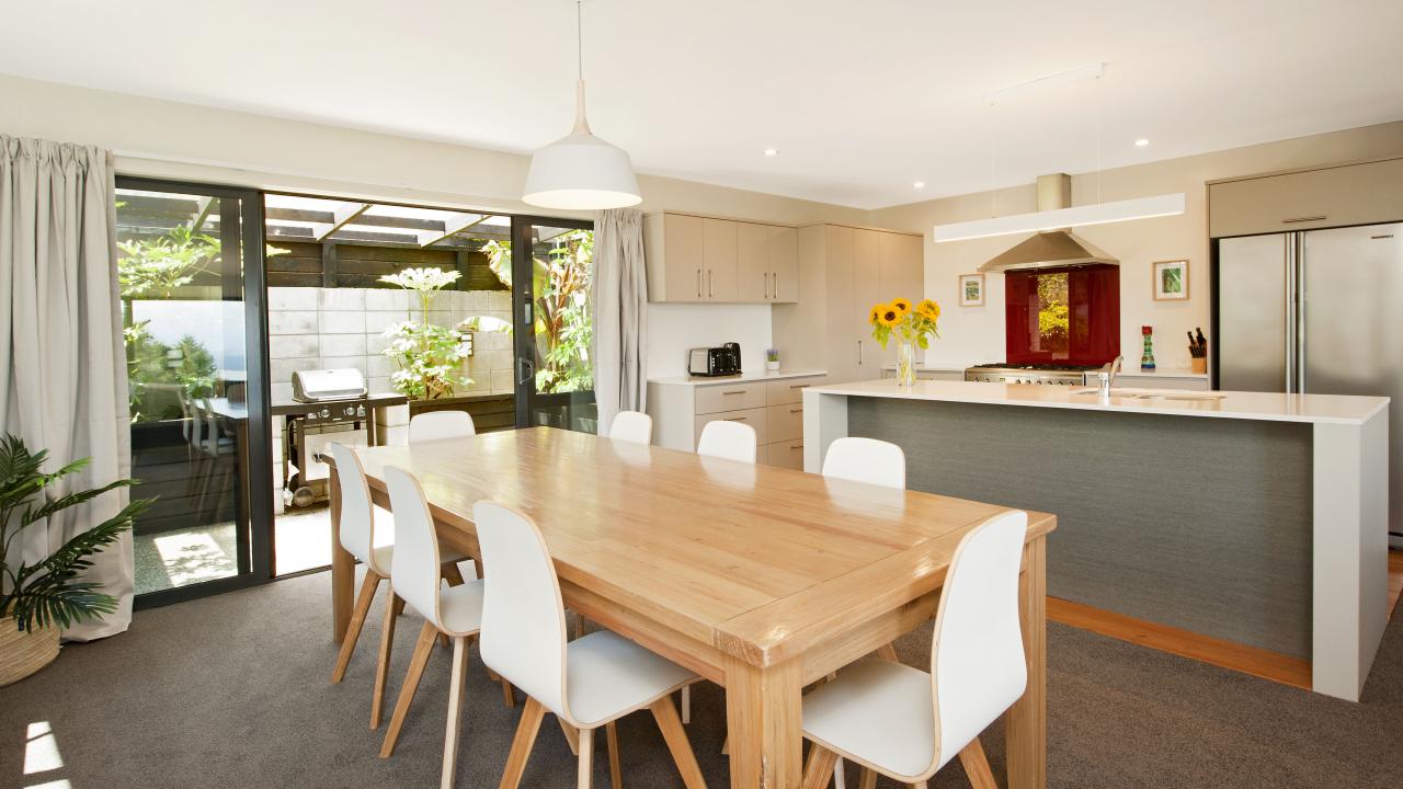 Dining and kitchen opening to outdoor BBQ area.
