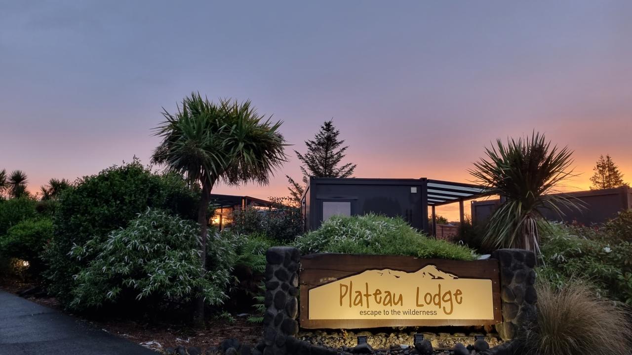 Sunset at Plateau Lodge entry sign.
