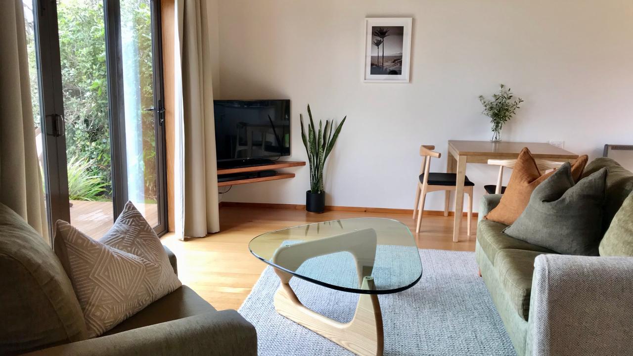 Villa living area with bi-fold doors that open out towards the bay.