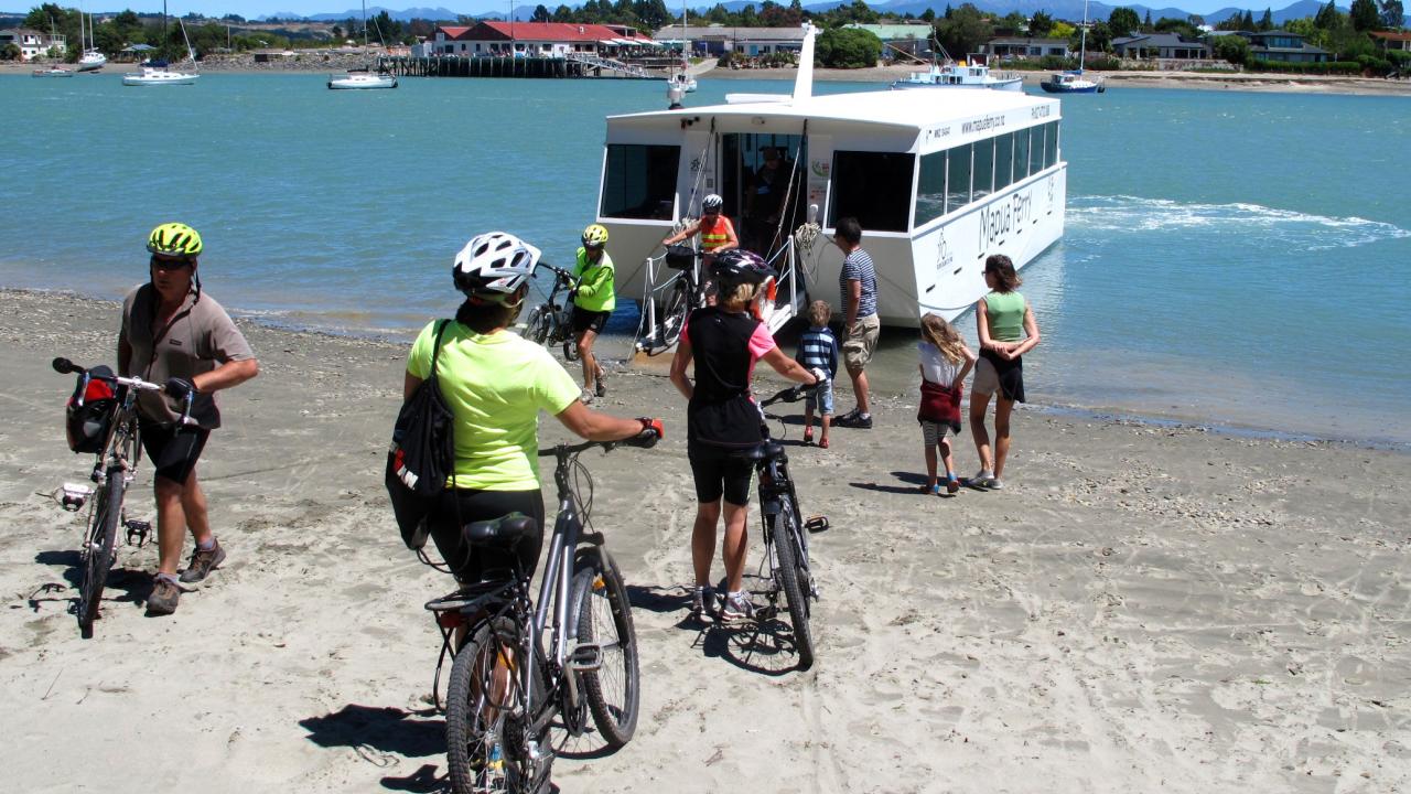 Cyclist loading onto the Mapua Ferry from Rabbit Island