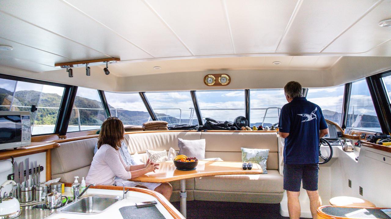 Interior of our catamaran Torea. Our open plan galley has plenty of room for indoor dining, while the 2 double and one single berths all have inner-sprung mattresses for a comfortable night aboard.