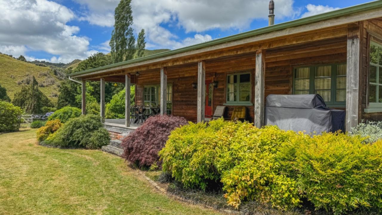 Covered porch with BBQ and outdoor dining area