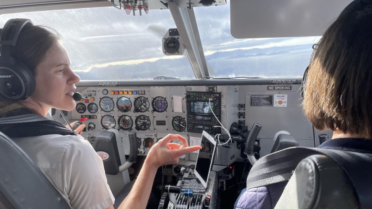 Golden Bay Air pilot pointing out the views on a Golden Bay Air scenic flight