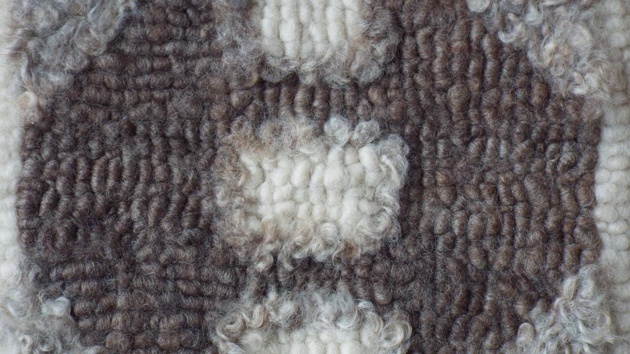 A student's completed hooked fleece chair mat, made at our Heirloom Hooked Fleece Rug Making Workshop.