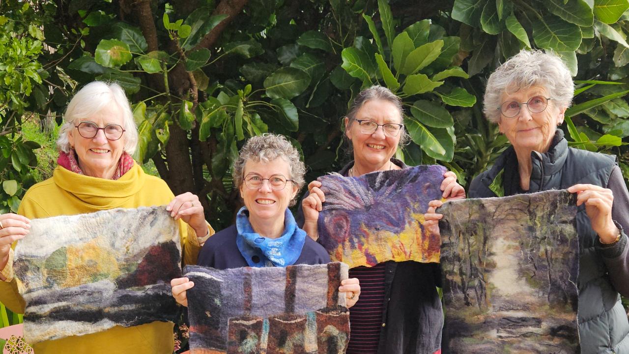 A group of students proudly show of their work at their Contemporary Feltmaking Workshop.