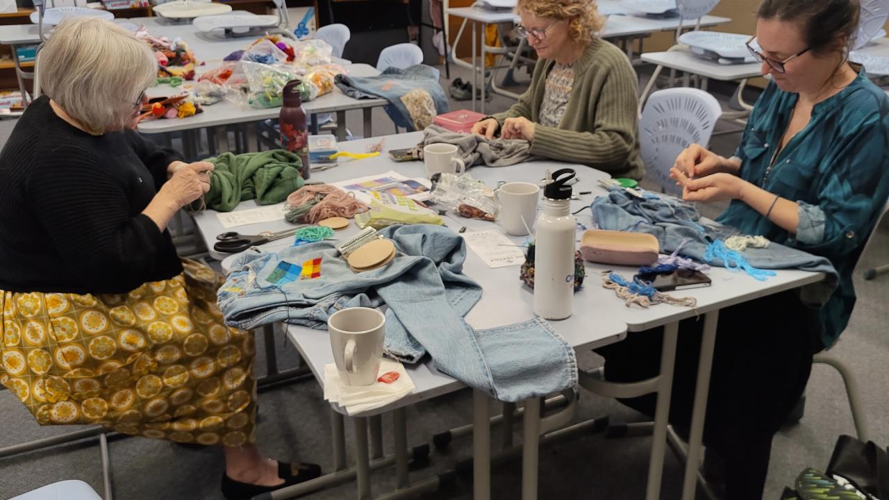 Students work on their creative repairs during their Visible Mending with a Speedweve Darning Loom Workshop.