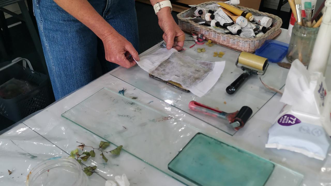 A student prints a design onto fabric at their Mono-Printing on Fabric Workshop.