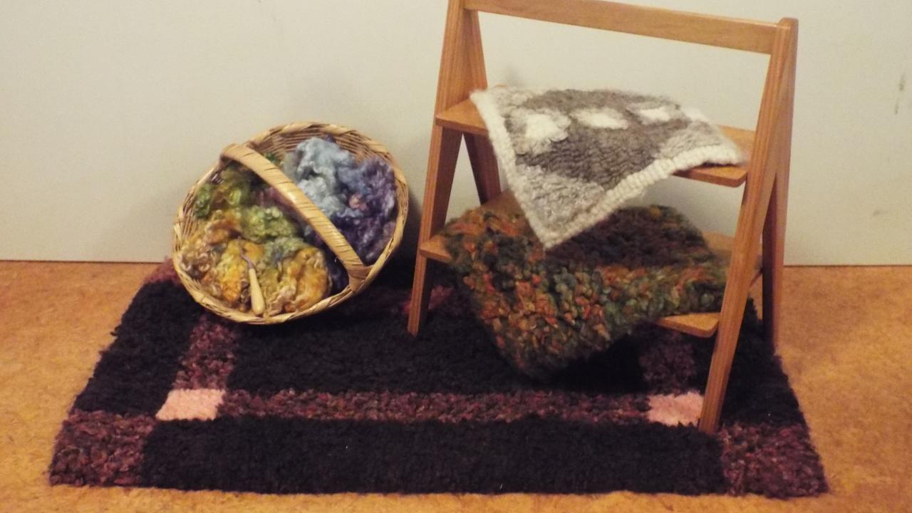 Student's work made at our Heirloom Hooked Fleece Rug Making Workshop, displayed alongside beautiful dyed New Zealand wools.