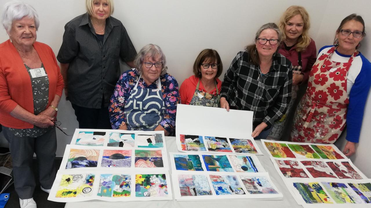 Students proudly show off their artworks made at their Create a Unique Collaged Floral Fantasy Workshop.
