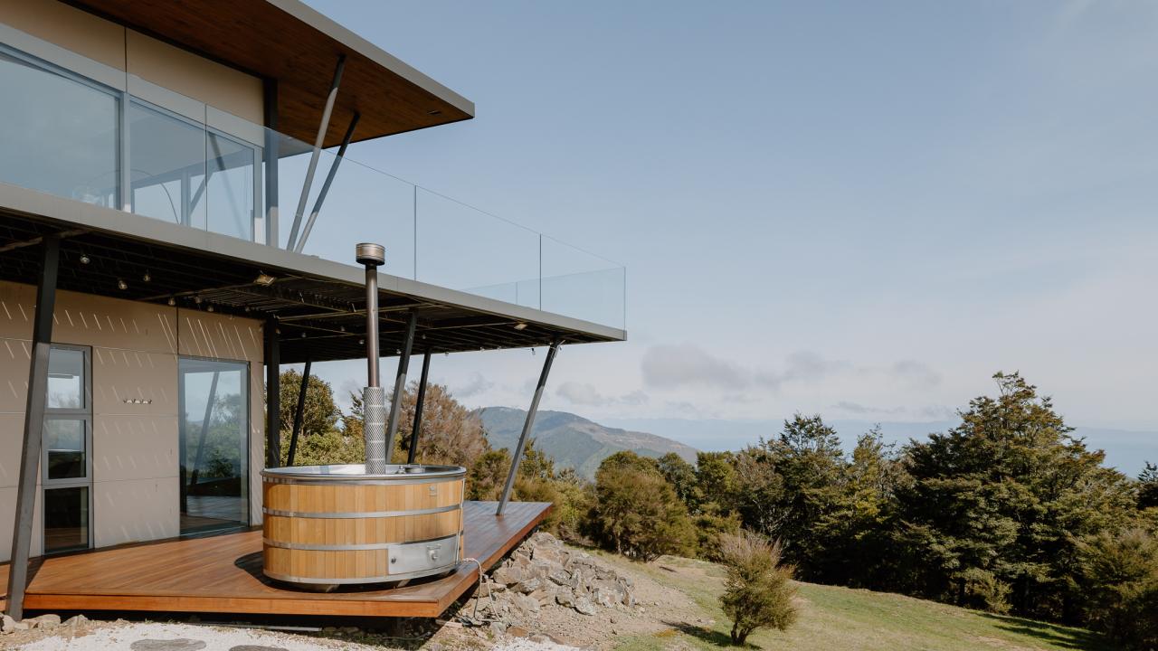 Wood fired cedar hot tub on the deck outside the primary bedroom