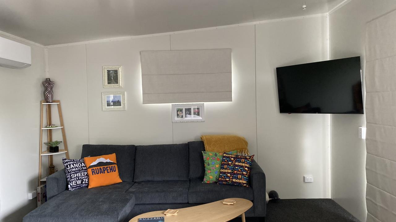 Lounge area, full sized couch, coffee table, 50 inch TV & heat pump for warmth.