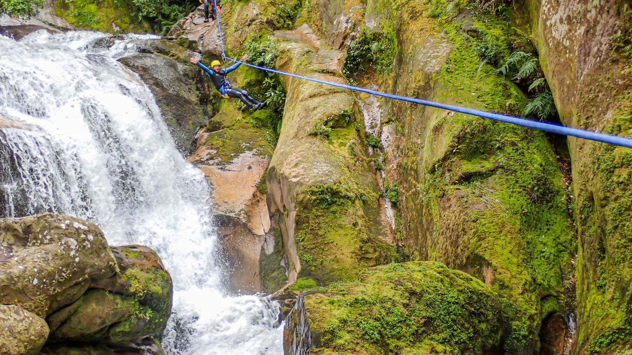Flying high on a zipline over waterfalls