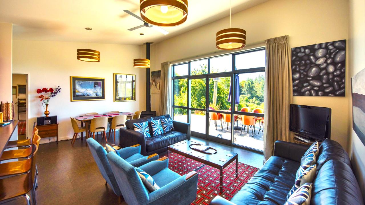 Lounge with views across valley to sea and mountains beyond.
