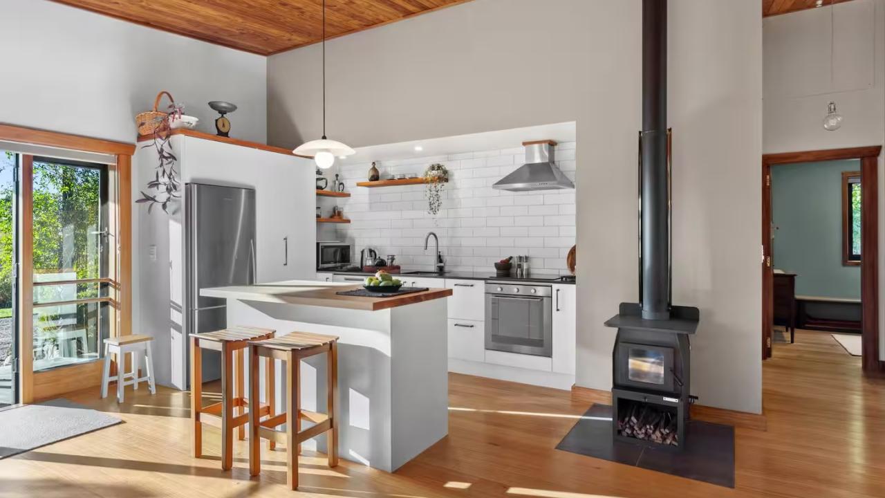 The kitchen area with bar stool seating at the island