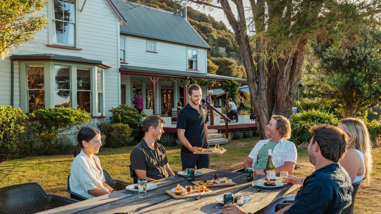 Outdoor dining surrounded by historic gardens and coastal calm