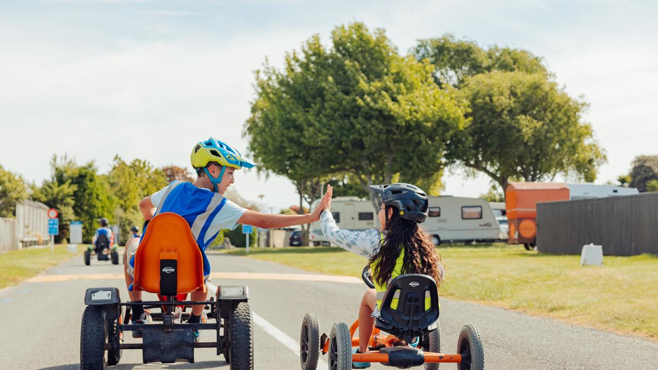 Kids having fun on the pedal karts at Tahuna Beach Holiday Park
