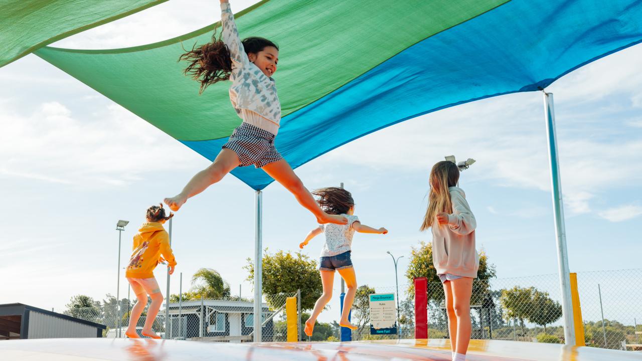 Children playing on the mega bouncy pillow at Tahuna Beach Holiday Park