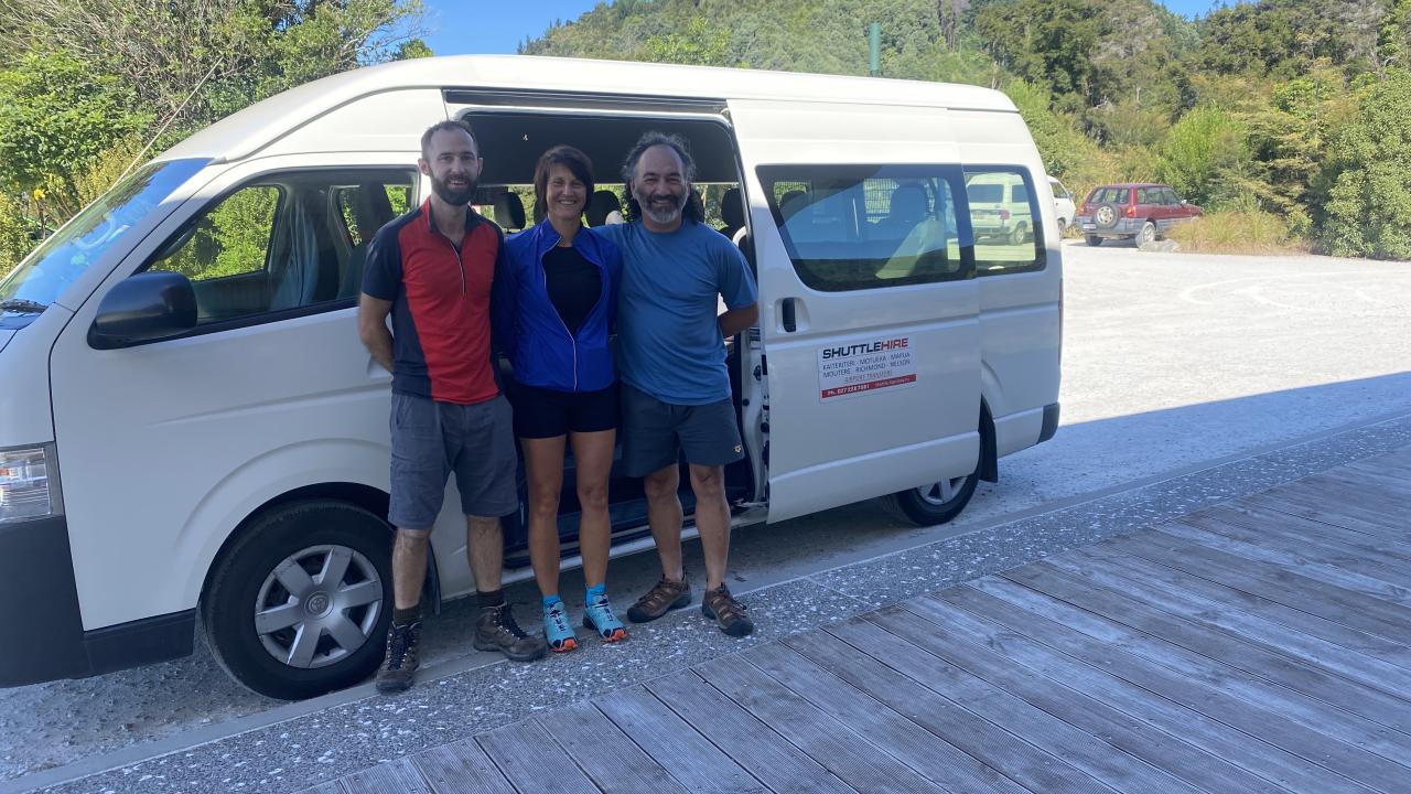A small group of walkers arriving at Mārahau to begin the Abel Tasman great walk - via a custom shuttle trip with Merv from Tapu Bay Shuttle.