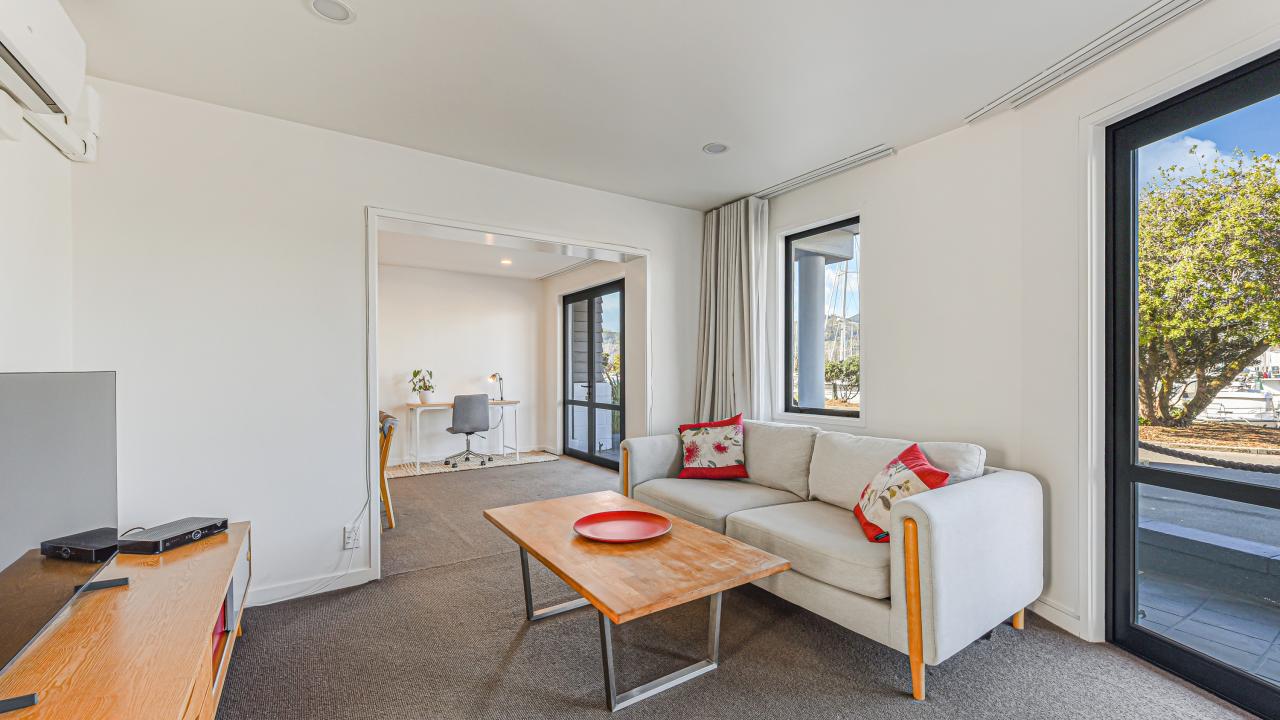 Marina Front Apartment, lounge looking through to desk and dining area