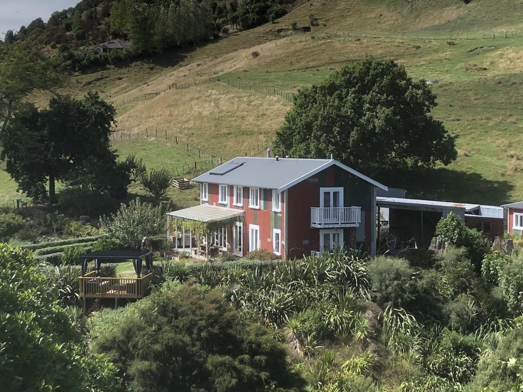 The Pear Orchard Lodge, the family-friendly lodge lawn, outdoor lounge and regenerating bush
